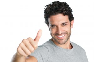 Happy smiling guy showing thumb up hand sign isolated on white background